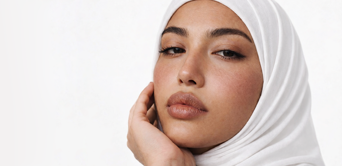 Woman applying Korean skincare, glowing skin, hijab, Saudi Arabia