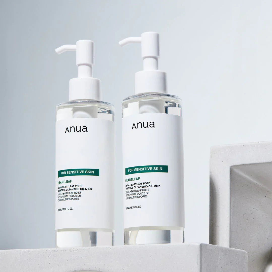 Anua Heartleaf Cleansing Oil Mild bottles displayed together with clean clinical skincare styling