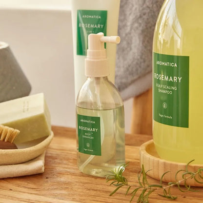 Aromatica Rosemary hair care products on a wooden surface with a neutral background