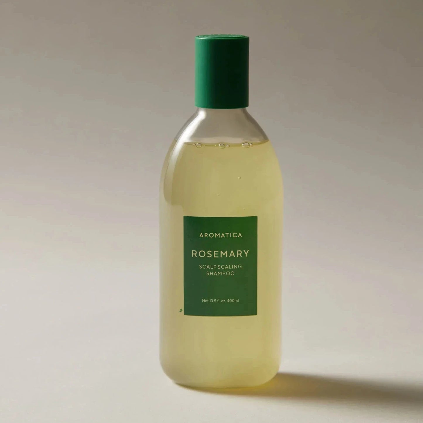 AROMATICA Rosemary Scalp Scaling Shampoo on neutral background highlighting herbal formula