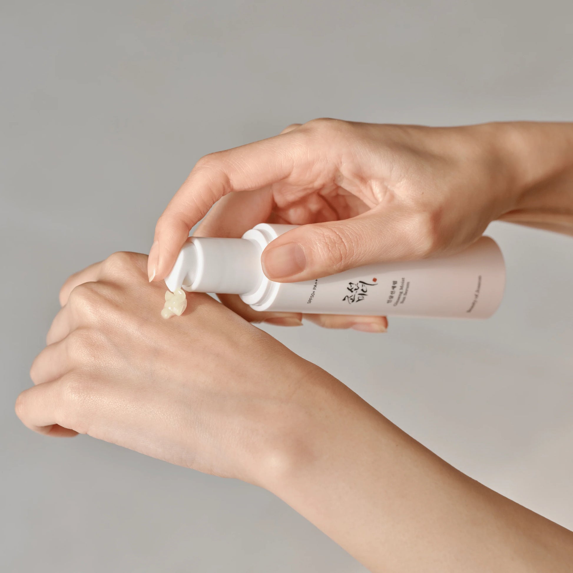 Applying Beauty of Joseon Ginseng Sun Serum SPF50+ with lightweight serum texture