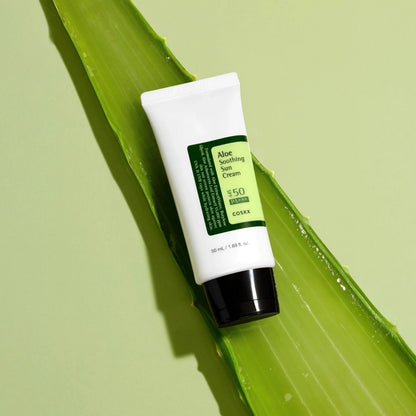 COSRX Aloe Soothing Sun Cream SPF50+ PA+++ placed on fresh aloe leaf highlighting soothing aloe vera ingredients and hydrating UV protection