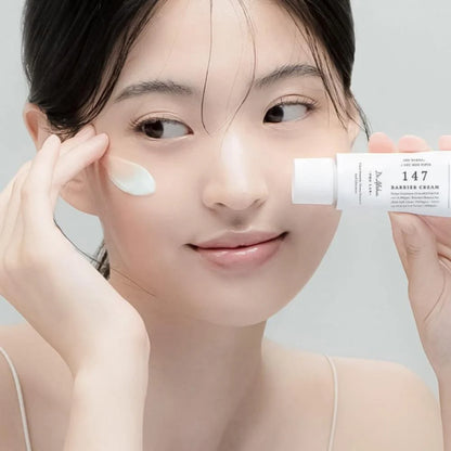 Woman applying Dr. Althea 147 Barrier Cream for nourished smooth and protected skin barrier care
