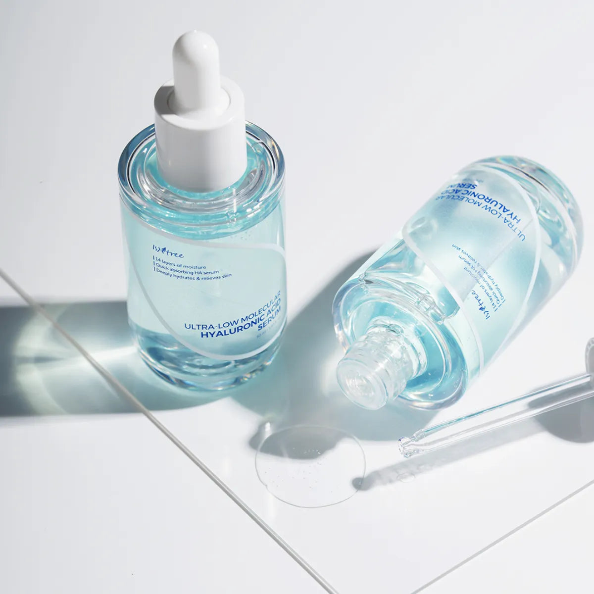Isntree Ultra-Low Molecular Hyaluronic Acid Serum glass bottle with dropper on clean reflective surface