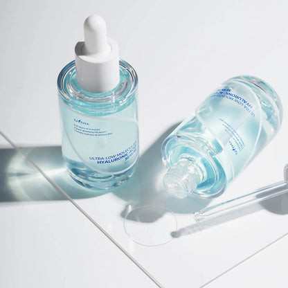 Isntree Ultra-Low Molecular Hyaluronic Acid Serum glass bottle with dropper on clean reflective surface