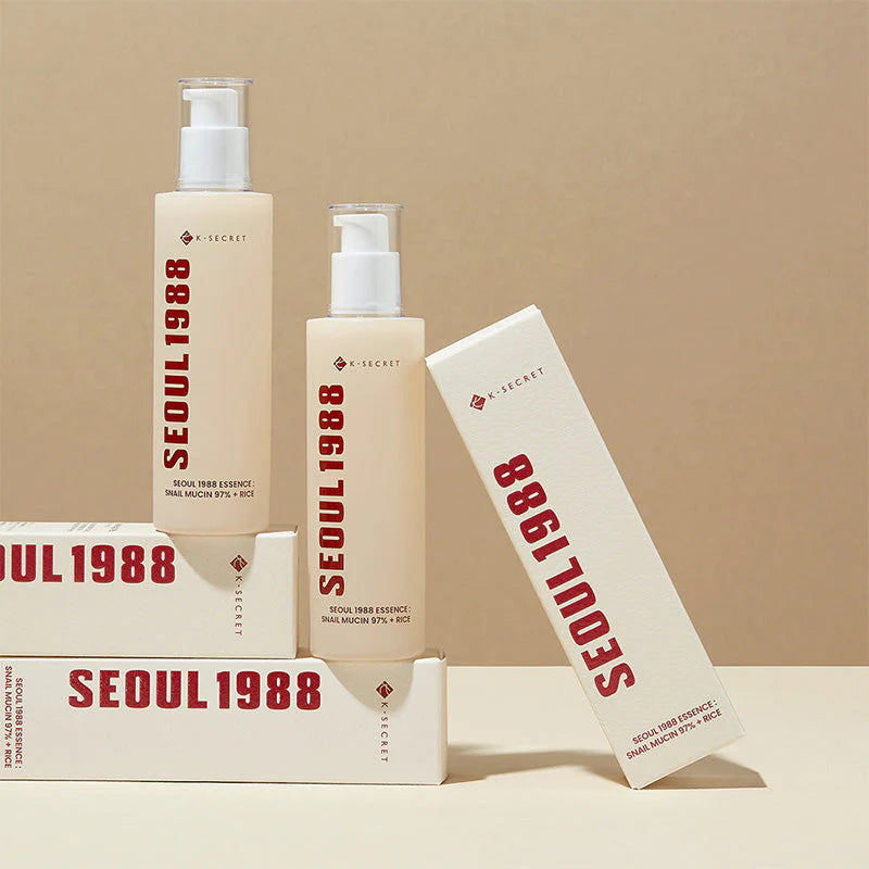 K-Secret Seoul 1988 Snail Mucin Essence bottle with its product box on a beige background