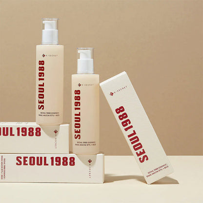 K-Secret Seoul 1988 Snail Mucin Essence bottle with its product box on a beige background