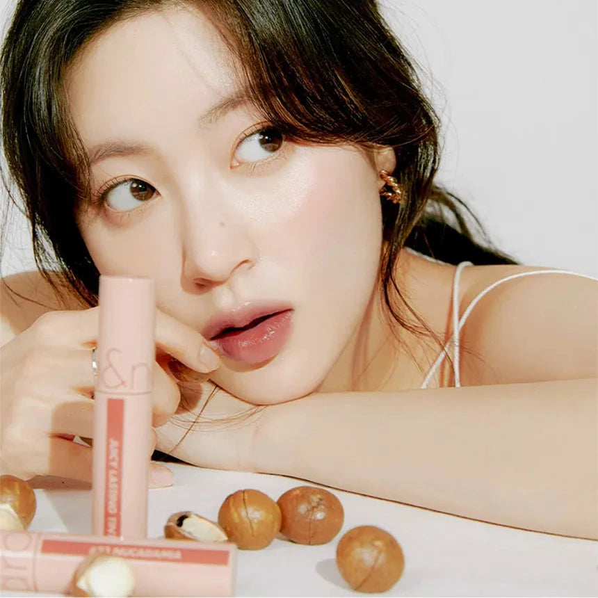 Model holding rom&nd Juicy Lasting Tint demonstrating everyday lip look