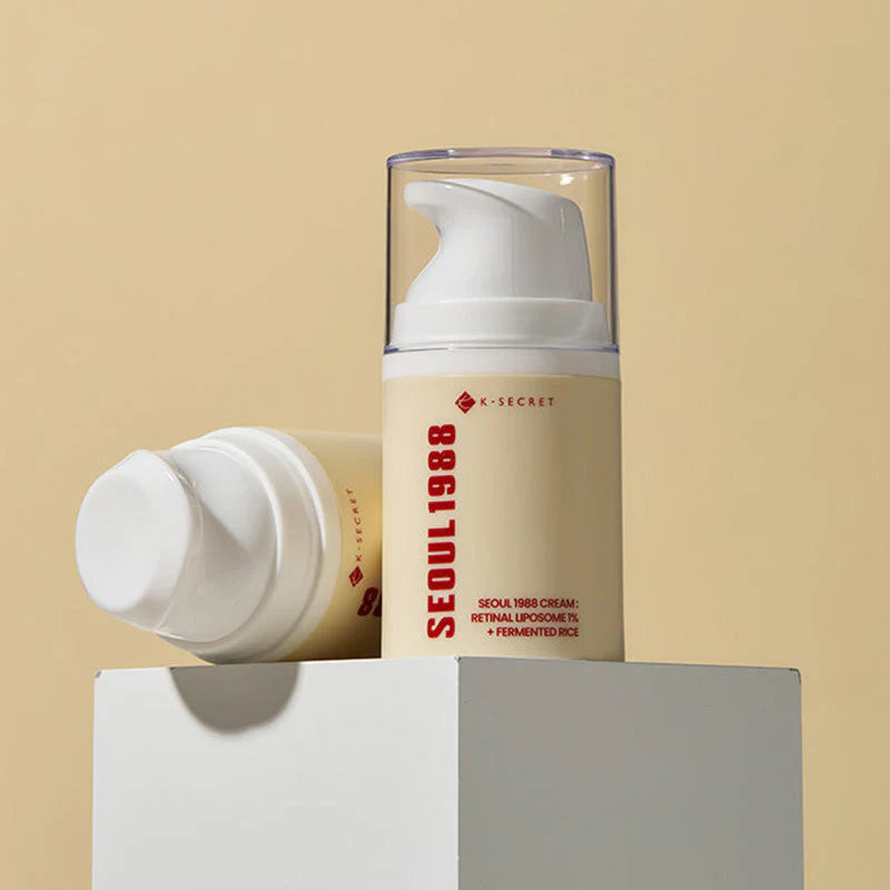 K-Secret Seoul 1988 Retinal Cream airless pump bottle with the cap off on a beige background