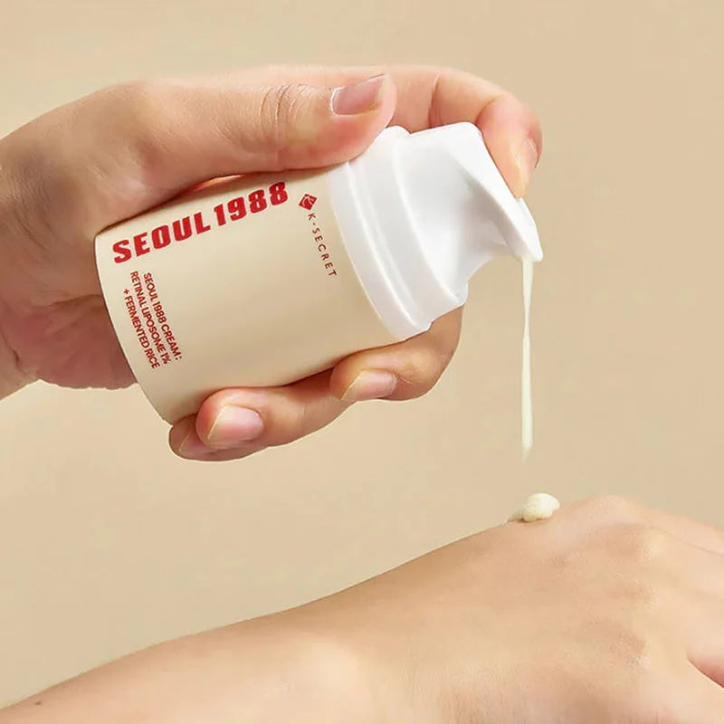 Hand dispensing K-Secret Seoul 1988 Retinal Cream onto skin, showing its lightweight texture