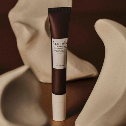SKIN1004 Madagascar Centella Probio-Cica Bakuchiol Eye Cream tube on fabric backdrop nourishing anti-aging eye cream