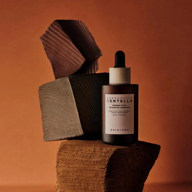 SKIN1004 Madagascar Centella Probio-Cica Intensive Ampoule bottle on textured backdrop anti-aging nourishing serum