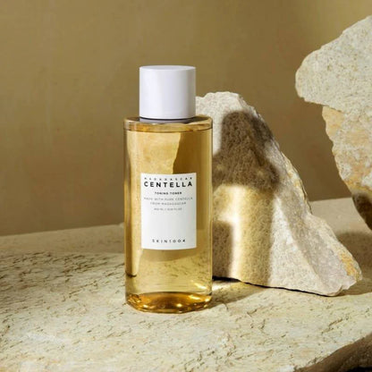 SKIN1004 Madagascar Centella Toning Toner bottle with stone backdrop soothing centella toner minimal aesthetic