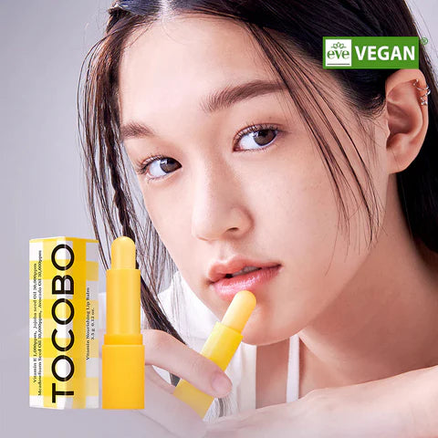 Woman applying TOCOBO lip balm for soft and moisturized lips