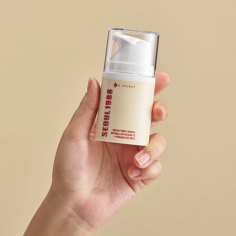 Hand holding the K-Secret Seoul 1988 Retinal Cream bottle, Korean anti-aging cream in Jeddah
