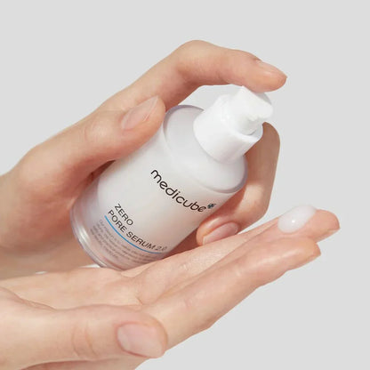 medicube Zero Pore Serum 2.0 pump bottle in hand lightweight pore refining serum application